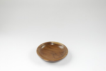 Wooden saucer or small wooden plate on a white background.