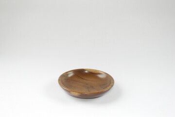 Naklejka premium Wooden saucer or small wooden plate on a white background.