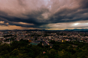Nature background from Phuket city viewpoint, Khao Rang viewpoint, with black rain clouds covering the evening, changing seasons according to the time of the rainy season.