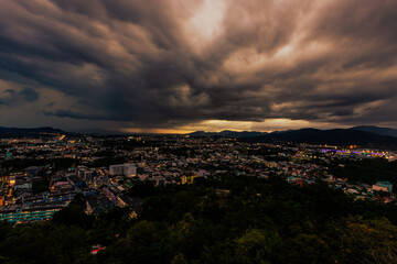 Nature background from Phuket city viewpoint, Khao Rang viewpoint, with black rain clouds covering the evening, changing seasons according to the time of the rainy season.
