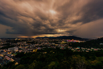 Nature background from Phuket city viewpoint, Khao Rang viewpoint, with black rain clouds covering the evening, changing seasons according to the time of the rainy season.