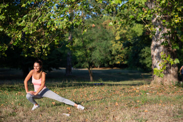 Young woman exercising in the nature in summer