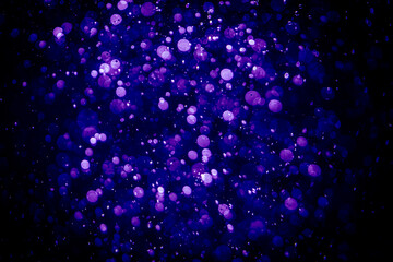 Blurred photo with purple violet and blue dots visible glittering, shining brightly look and feel luxurious