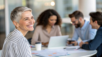 Smiling woman in office with colleagues, teamwork and collaboration
