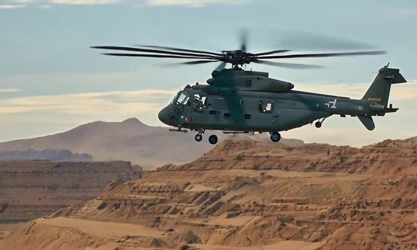 Military transport helicopter flying over desert mountains, heavy lift cargo chopper in flight, tactical aviation mission in arid canyon
