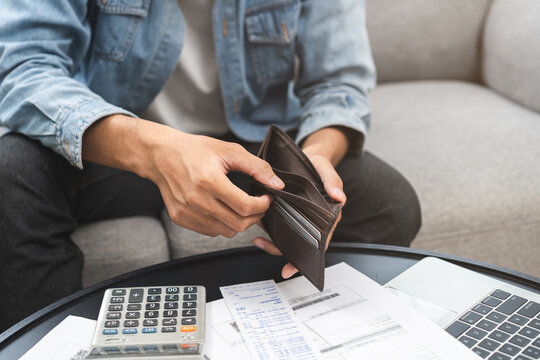Debt financial concept, stressed problem people asian man, male hand open empty wallet not have budget of money to pay no have credit card, not able payment bill, loan or expense with bank, bankruptcy
