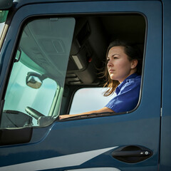 Female truck driver in cabin