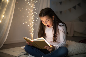 Naklejka premium A cute girl sits cross-legged in her bedroom, amazed as a magical forest with fairies and birds emerges from an open book on her lap, connected by glowing platinum-gold fractal light