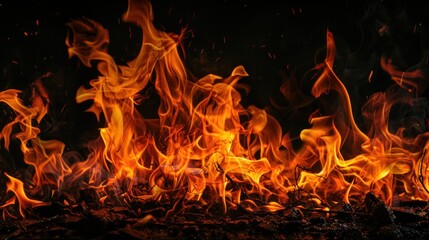 Fiery flames burning intensely against a dark background, ideal for dramatic design