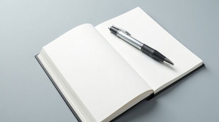 Blank open book with a sleek pen resting on its pages, ideal for showcasing your ideas and designs, ready to capture your thoughts and create new beginnings.