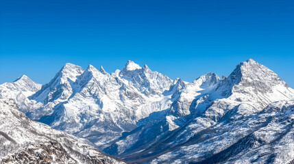 Obraz premium Majestic snow-capped mountains under a clear blue sky, panoramic view of a winter landscape, ideal for travel brochures
