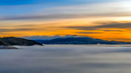 Obraz premium Mountain sunrise, fog-covered valley, city skyline, tranquil landscape. Use travel brochure, calendar