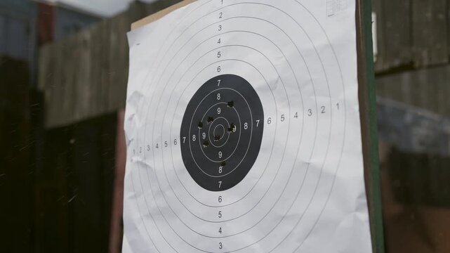 Close up shot of target being riddled with bullets at gun range, static shot