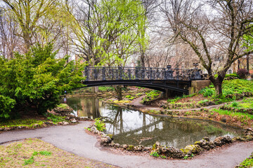 Grotto Bridge, aka Lafayette Park Bridge, with daffodil and tulip flowers in bloom on a Spring day...