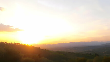 Fototapeta premium Tuscan sunset over rolling hills and valleys. Peaceful landscape ideal for travel brochures