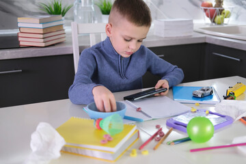 Education, school, learning difficulties, reading difficulties. Child plays with smartphone instead...