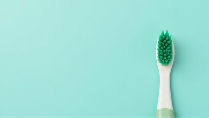 Green Bristled Toothbrush on Aqua Background