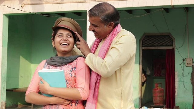 Rura indian father putting Police Inspector Khakhi Cap on his daughter with school notebooks in hand. Girl Dream to become IPS officer, Job or career opportunities. Relationship bonding.4k