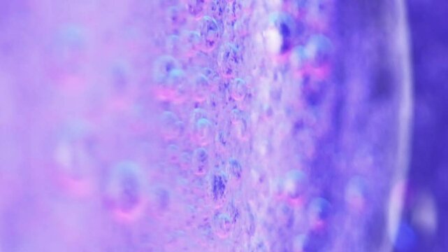Serum bubbles. Oil foam. Defocused purple blue color translucent fizzy ink water blend round blob floating motion abstract art background.