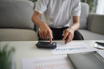 Man using calculator calculate finance and another hand holding pen