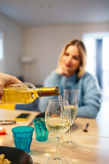 Lesbian couple celebrating valentine's day with romantic dinner and white wine