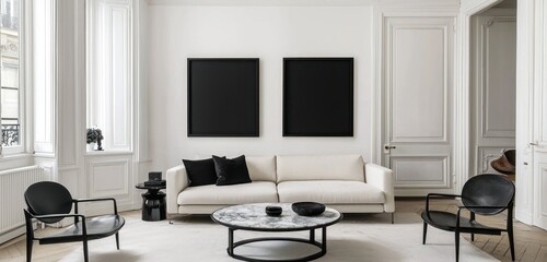 Chic living area with black frames, cream sofa, vintage marble table, designer chairs, natural light.