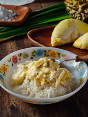 Sticky rice with durian on wooden background