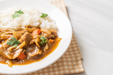 Japanese curry rice with sliced pork, carrot and onions