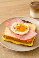 bread toasted cheese topped ham and fried egg with pork sausage