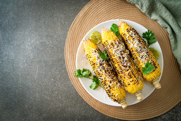 barbecue and grilled corn with cheese and lime