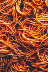 Delicious spaghetti topped with rich tomato sauce and fresh herbs served in a vibrant setting
