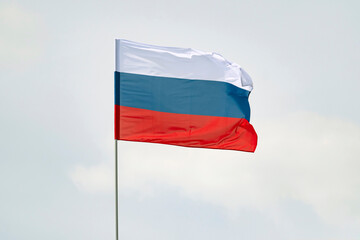 Russian Federation flag on a blue sky background. Celebration of Independence Day of Russia on June 12.