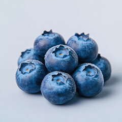 Obraz premium Fresh blueberries with frosty blue skin stacked together, showcasing their vibrant color and