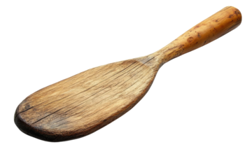 Wooden kitchen utensil used for mixing and serving food in a rustic culinary setting