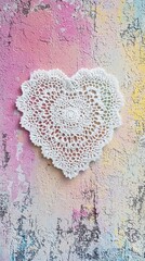 Intricate lace doily in heart shape on vintage pastel surface