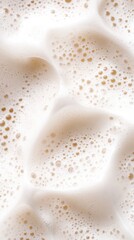 Close-up of creamy foam texture with airy bubbles creating a soft abstract pattern