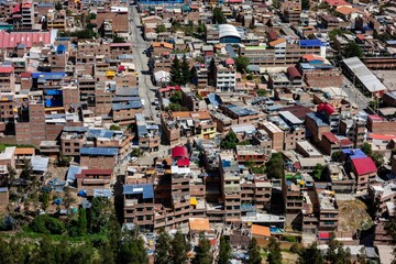 Aerial view of vibrant rooftops in Huaraz, Peru, nestled in the Andes.
