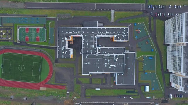 Aerial top view of the school with stadium and outdoors sports infrastructure.
