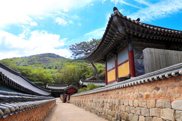 Fototapeta premium Stone walls and pavilion in traditional korean style, Beomeosa Temple, Busan, South Korea. Beautiful landscape with mountains and Beomeosa Temple complex, Busan, Republic of Korea