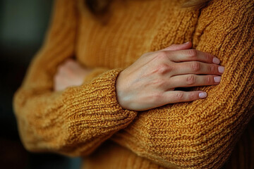 Woman in yellow sweater, hands cupped, admiring a blooming sunflower in a sunlit field.