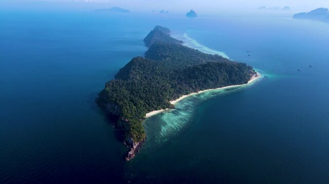Journey through the serene paradise of Koh Kradan, Thailand, where lush greenery meets crystal-clear waters.
