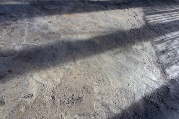 Artistic Shadows of Sunlight on a Raw Concrete Surface