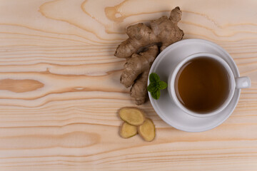 A cup of tea and ginger slices on a wooden table flatlay copyspace