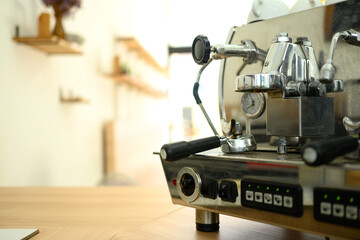 Close up of an espresso machine on a wooden counter in a minimalist cafe