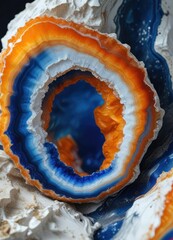 Obraz premium Agate geode with striking blue fiery orange and white colors, precious stone, earthy tones , rock