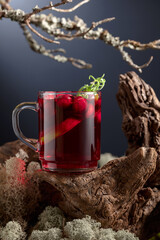Hot drink with cranberries, lime, and rosemary.