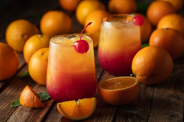 Classic tequila sunrise cocktail on an old wooden table.