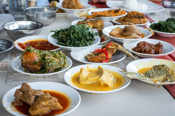 Indonesian traditional food from Minang Padang. Popular dishes from a Padang eatery, served on layers of plate stacks.