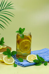 Lemon tea ice on blue napkin with lemon slices and mint leaves. Isolated background.
