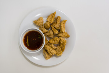 Fried fish balls served with simmered sugar dipping sauce with chili, Thai appetizer. Top view